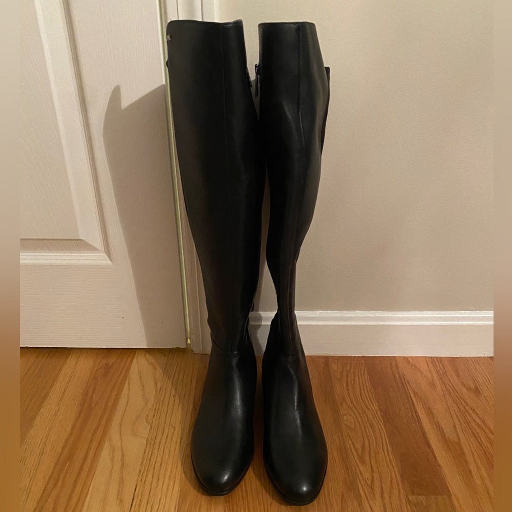 Black leather tall boots, size 8 1/2. Brand new, never worn. Stretchy back half.
